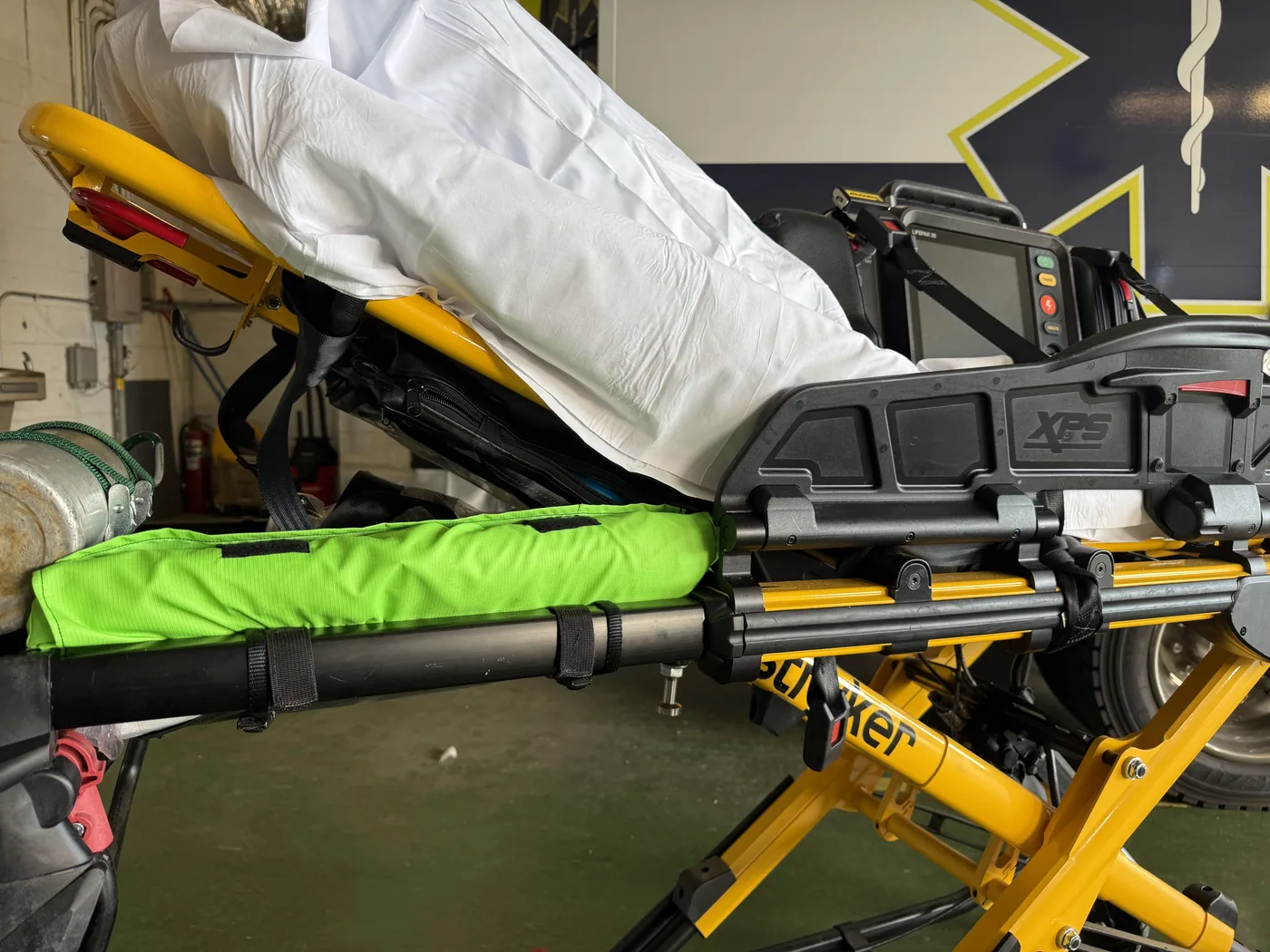 Storage case strapped to stretcher frame